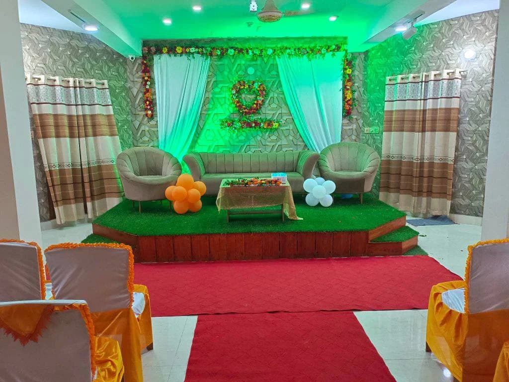 Green birthday stage decoration at Crystal Community Center, Gobindaganj