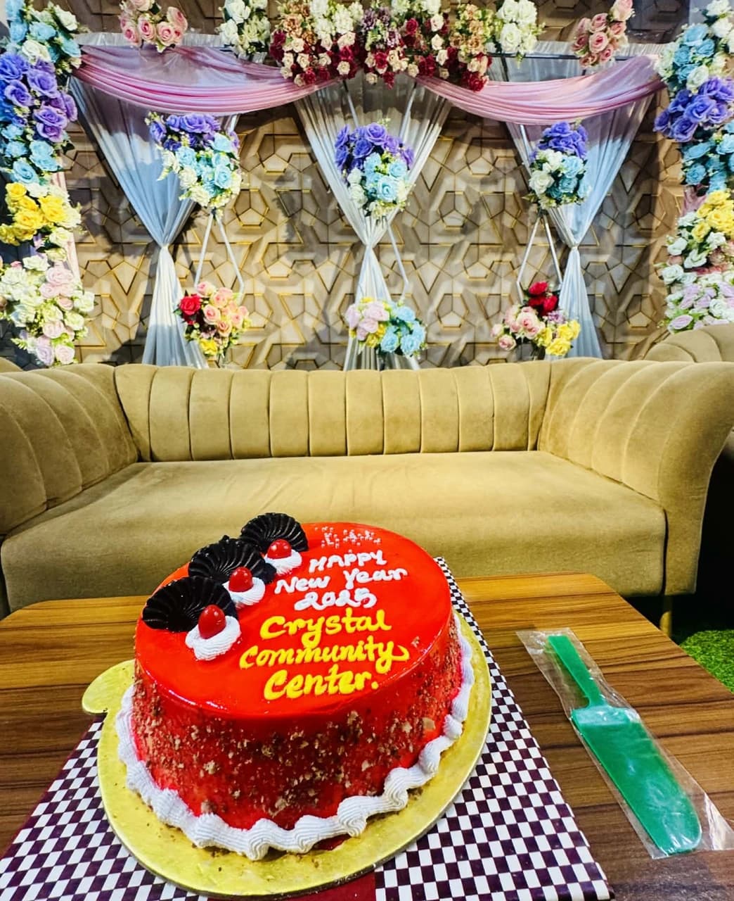 Celebration cake and floral stage at Crystal Community Center, Gobindaganj
