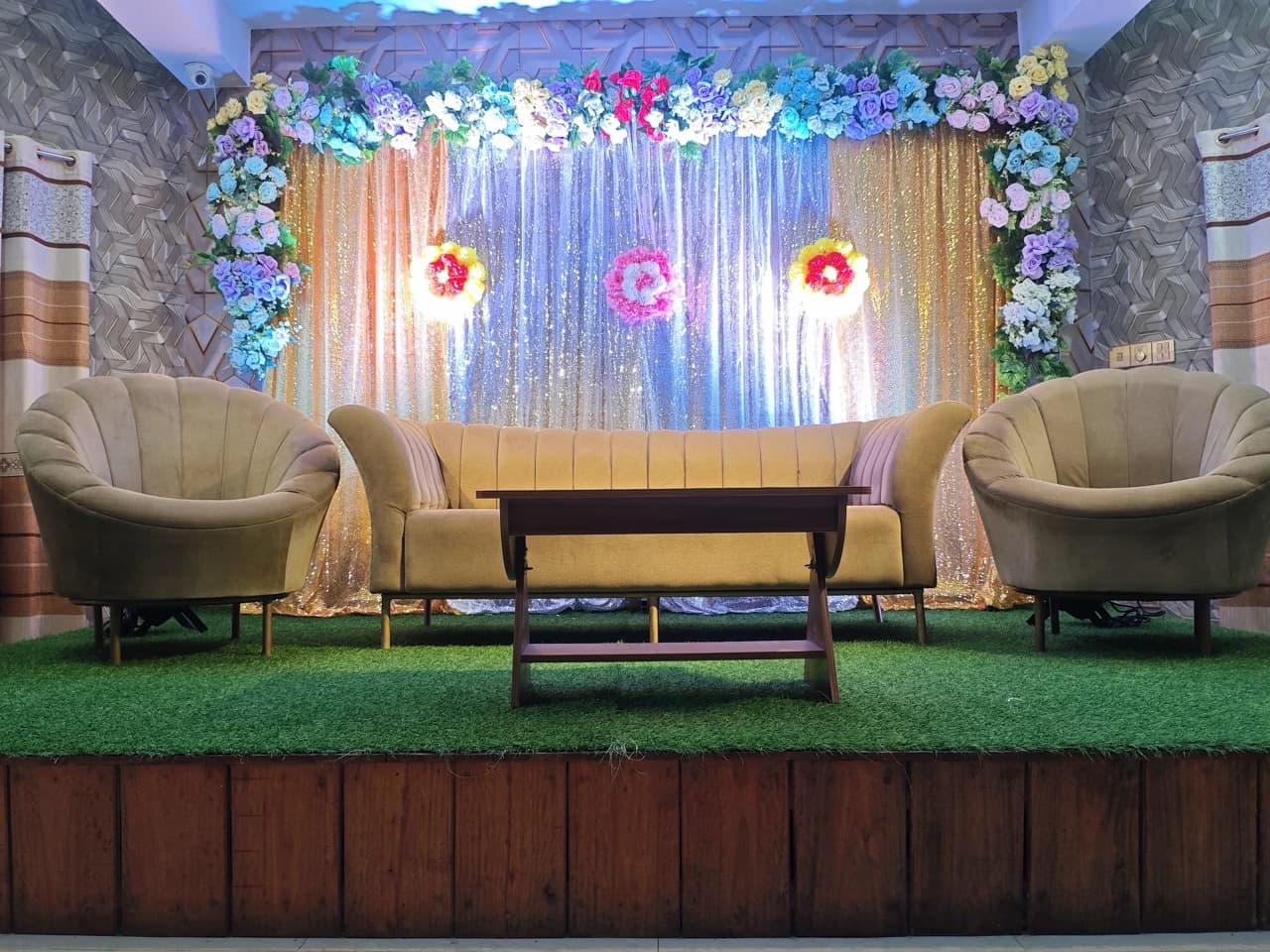 Illuminated floral stage with sofa seating at Crystal Community Center, Gobindaganj